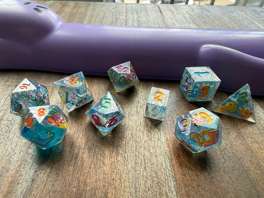Set of colorful dice with numbers on a wooden surface