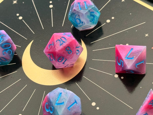 Colorful polyhedral dice on a black surface with star patterns