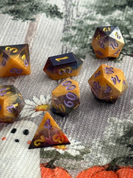 Set of polyhedral dice with purple numbers on a textured surface