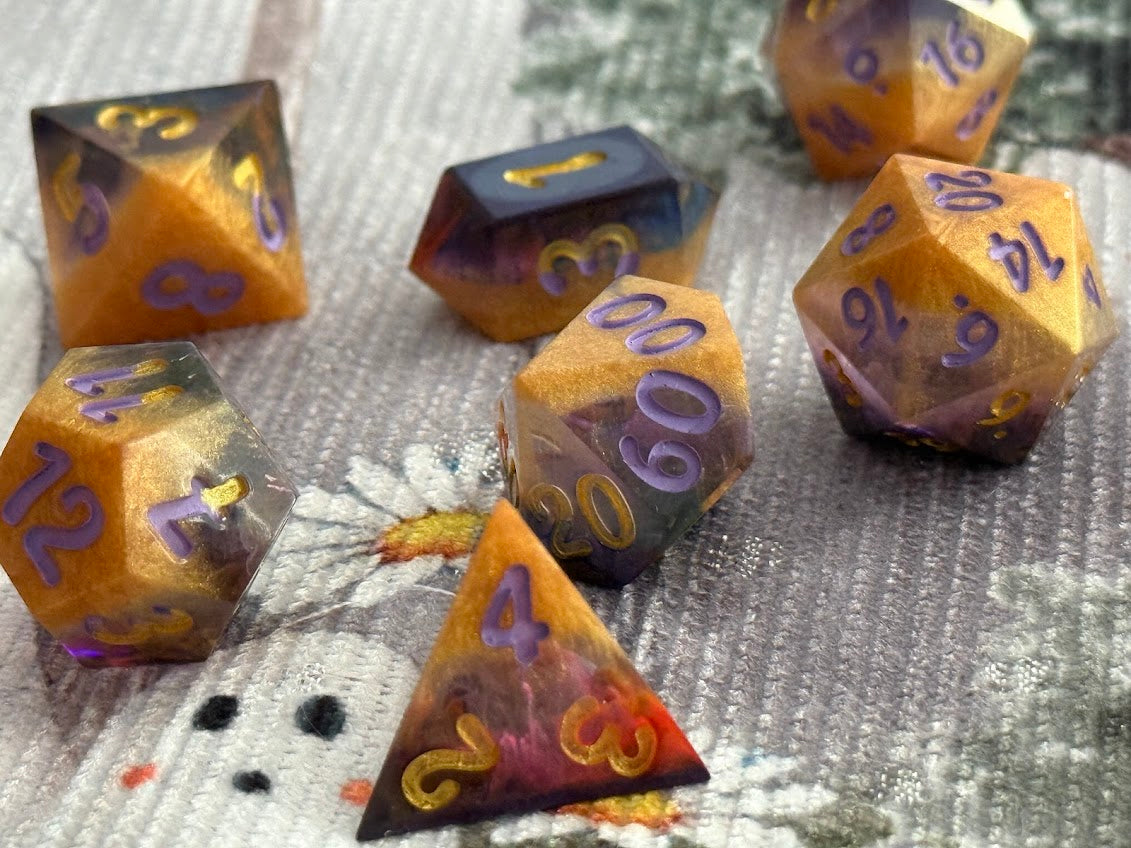 Set of polyhedral dice with purple numbering on a textured fabric background