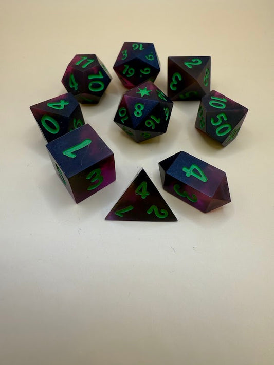 Set of dice with purple and green numbers on a white background