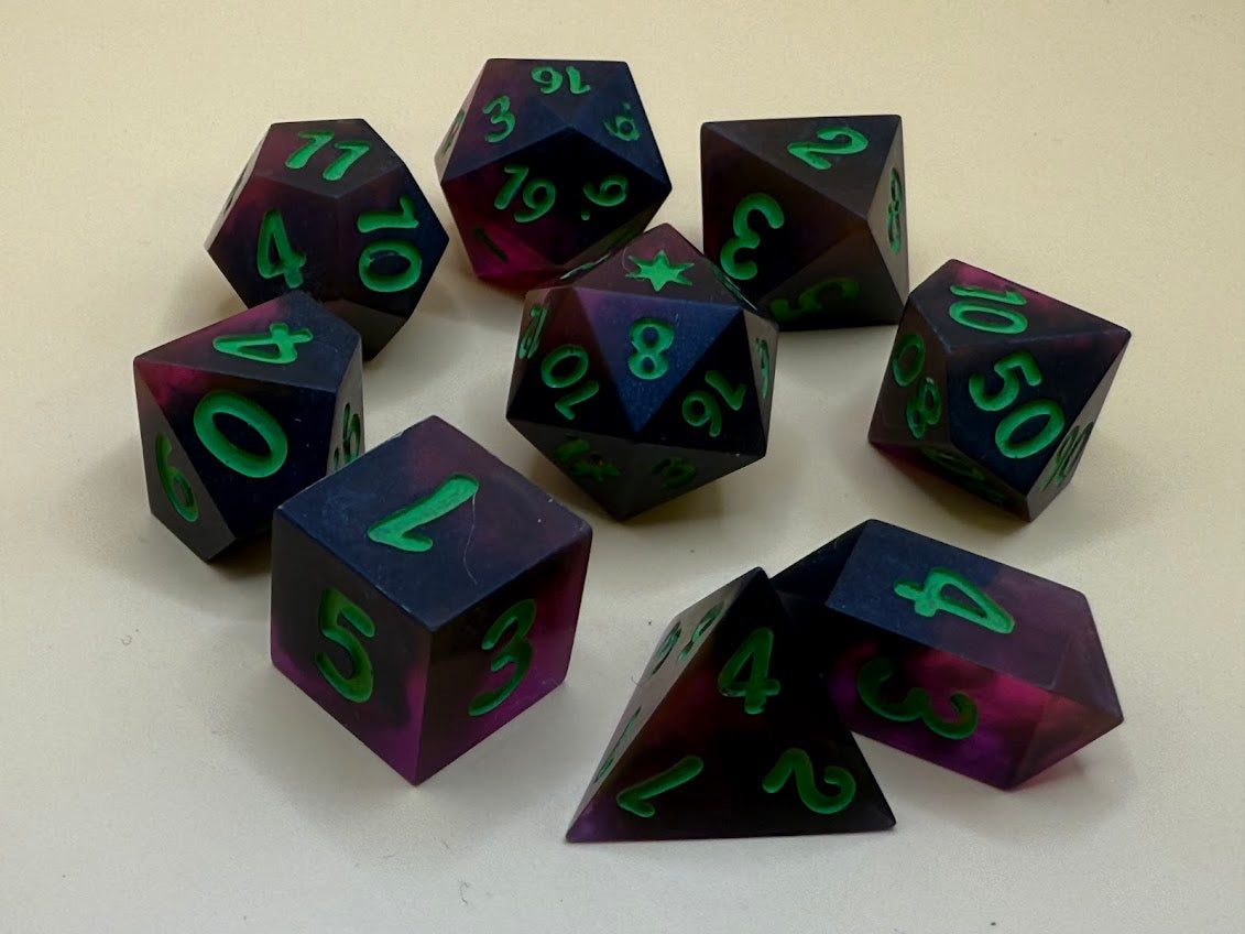 Set of purple polyhedral dice with green numbers on a white background