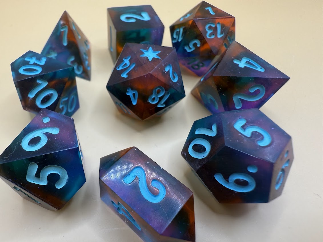 Set of polyhedral dice with blue numbers on a light background