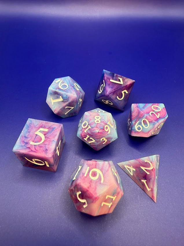 Set of colorful polyhedral dice on a blue background
