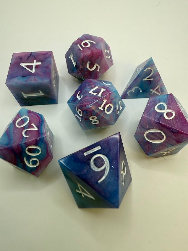 Set of purple and blue dice with numbers on a white background