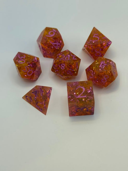 Set of polyhedral dice with orange and purple color scheme on a white background