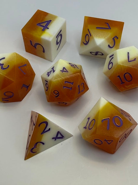 Set of polyhedral dice with orange and white color scheme on a white background