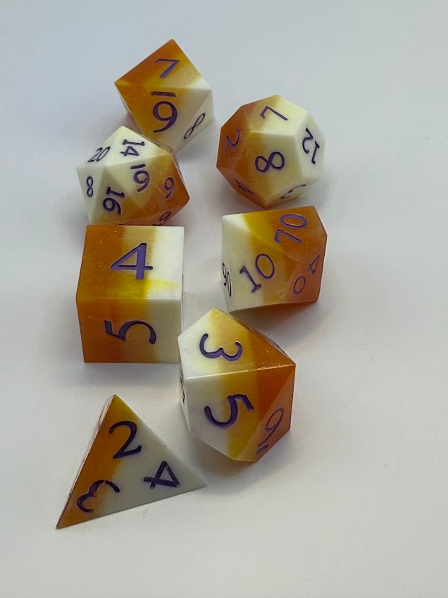 Set of polyhedral dice with orange and white color scheme on a white background