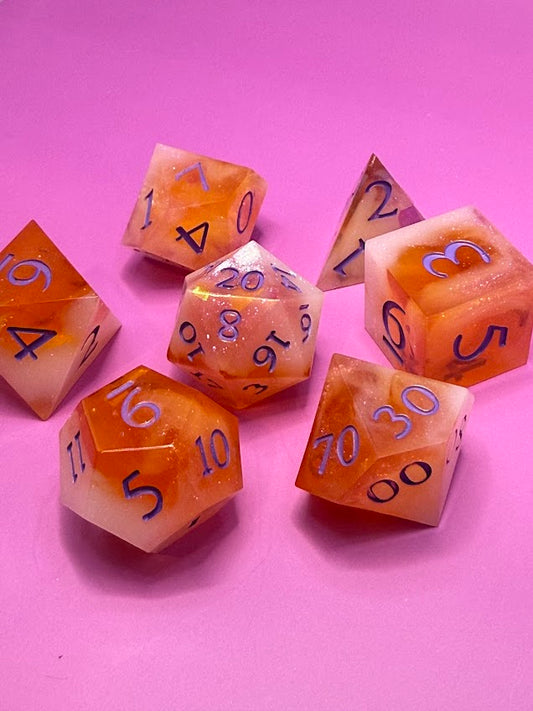 Set of orange polyhedral dice with black numbers on a pink background