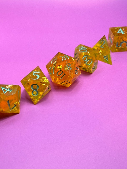 Yellow dice with green numbers on a pink background