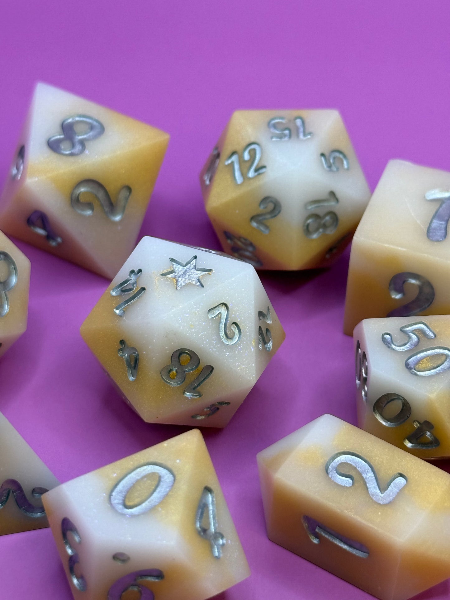Set of polyhedral dice with numbers on a pink background
