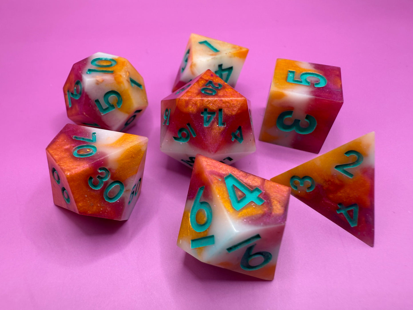 Colorful dice with numbers on a pink background