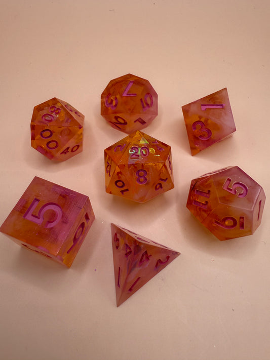 Set of colorful polyhedral dice on a beige background
