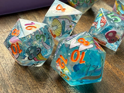 Set of colorful polyhedral dice with numbers on a wooden surface