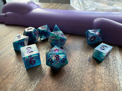 Set of blue dice with star patterns on a wooden surface