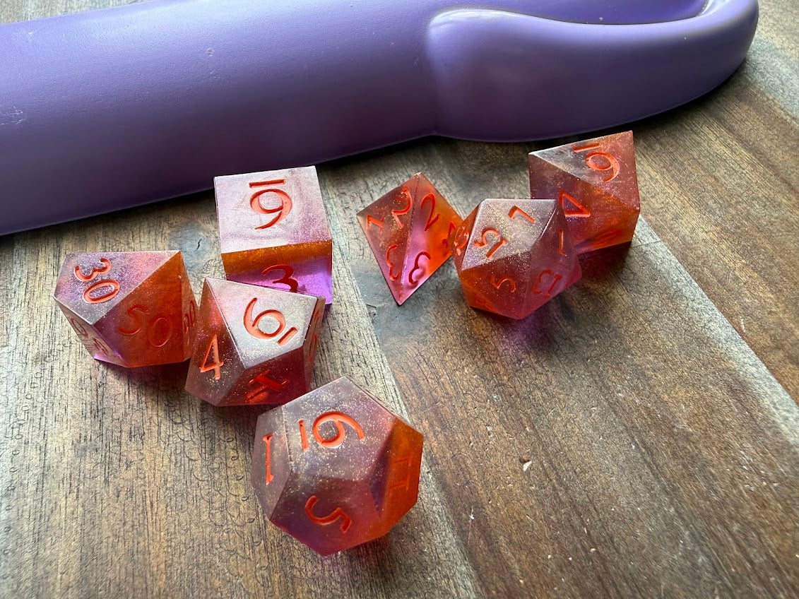 Set of polyhedral dice with numbers on a wooden surface