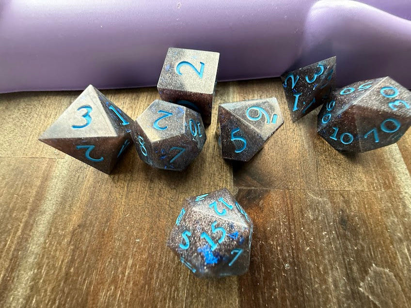 Set of polyhedral dice with numbers on a wooden surface