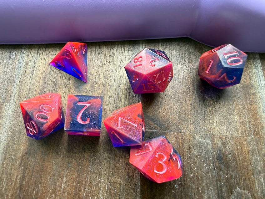 Set of colorful polyhedral dice on a wooden surface