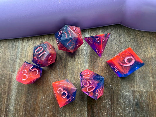 Set of colorful polyhedral dice on a wooden surface