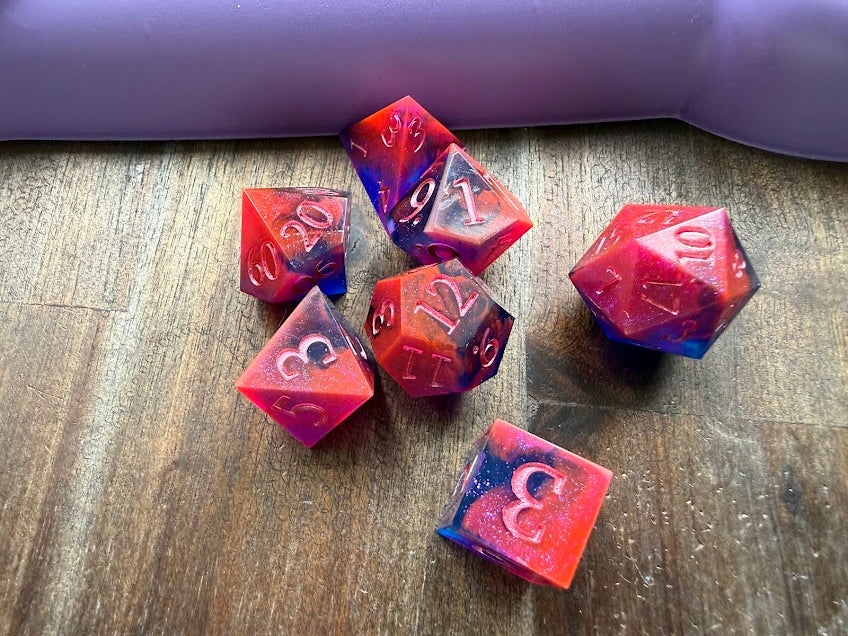 Set of red and blue polyhedral dice on a wooden surface