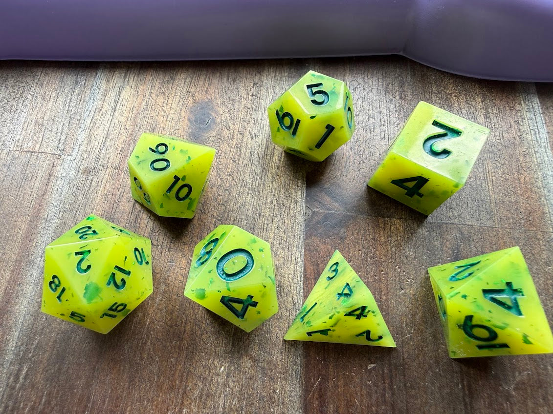 Set of yellow polyhedral dice on a wooden surface