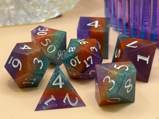polyhedral sharp-edge, a set of seven in green, orange and purple. Numbers are inked in white.