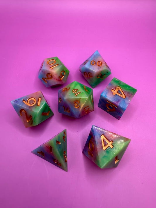 Set of colorful polyhedral dice on a pink background