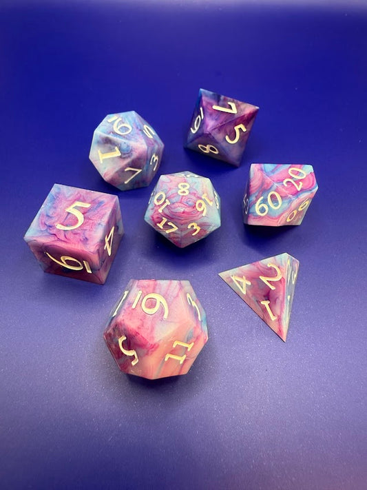 Set of colorful polyhedral dice on a blue background
