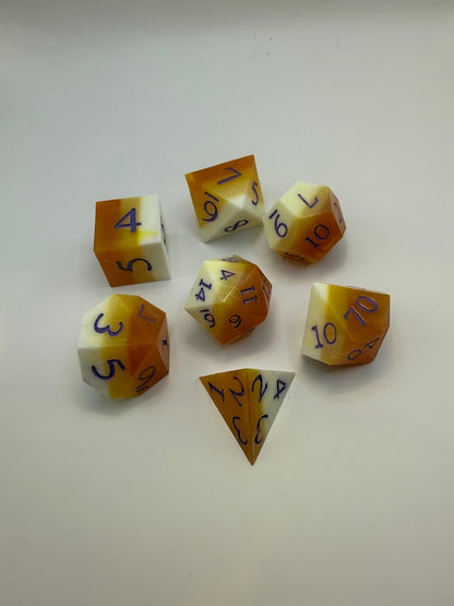 Set of polyhedral dice with brown and white color scheme on a light gray background