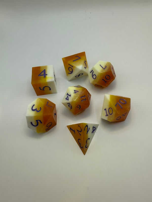 Handmade orange and white polyhedral dice set with blue numbers for tabletop RPGs