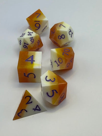 Set of polyhedral dice with orange and white color scheme on a white background