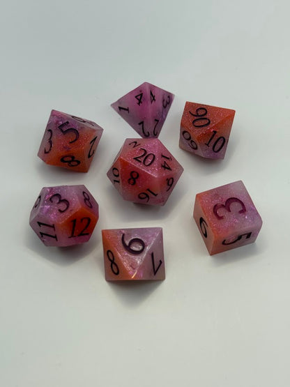 Set of purple and orange dice with black numbers on a white background