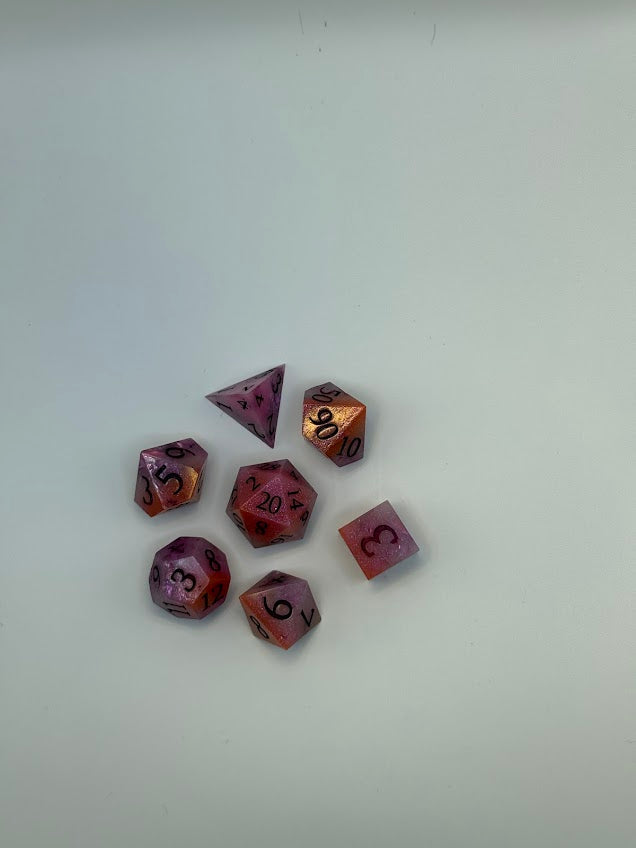 Set of purple polyhedral dice on a white background