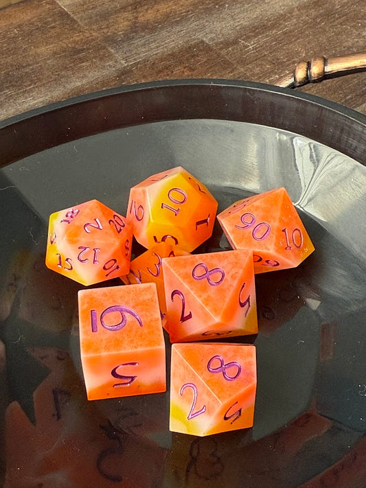 Set of colorful polyhedral dice on a reflective surface