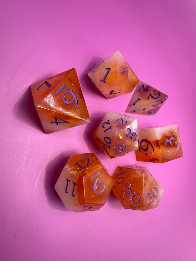 Set of polyhedral dice with numbers on a pink background