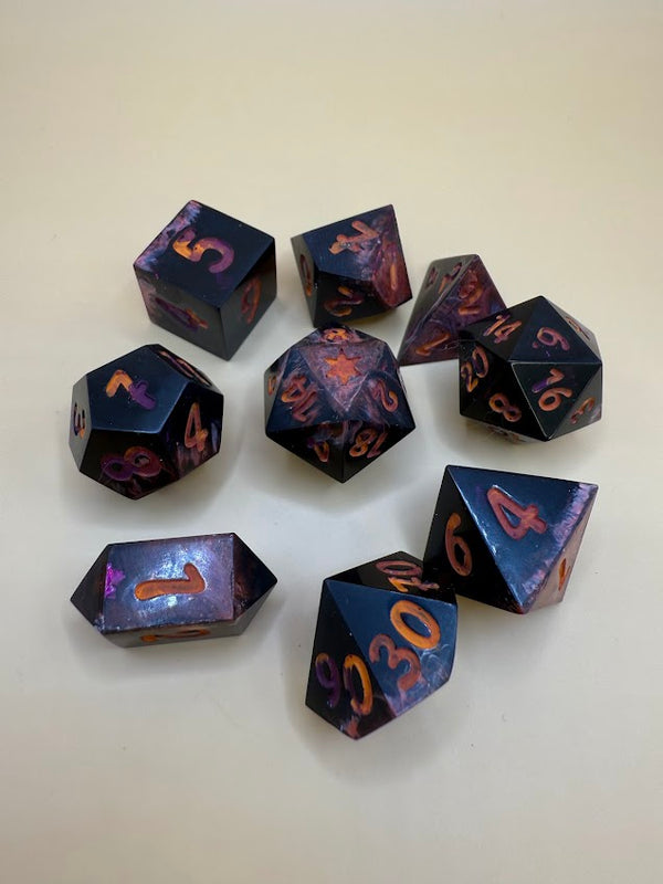 Set of black polyhedral RPG dice with red and orange numbers on beige background