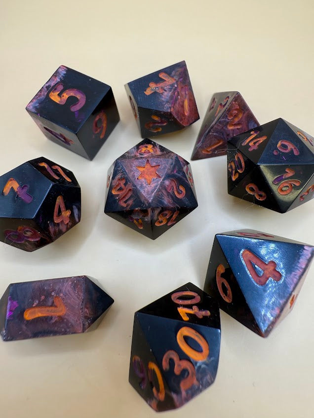 Set of polyhedral dice with purple and orange numbers on a white background