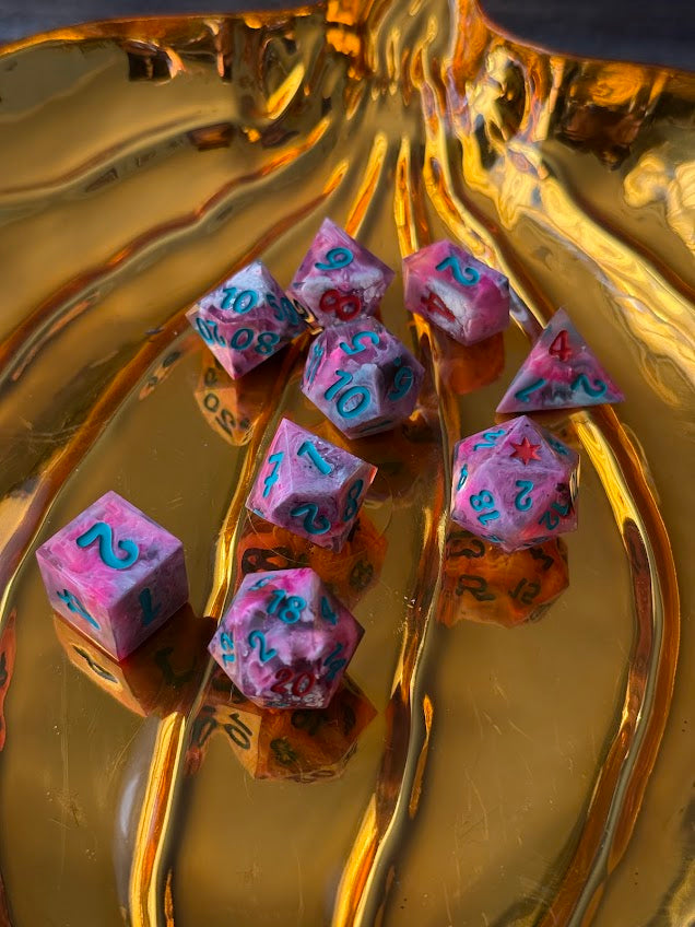 Set of colorful dice on a reflective gold surface