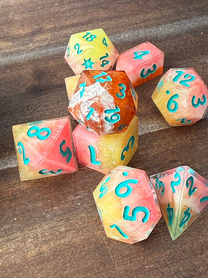 Set of colorful polyhedral dice with numbers on a wooden surface
