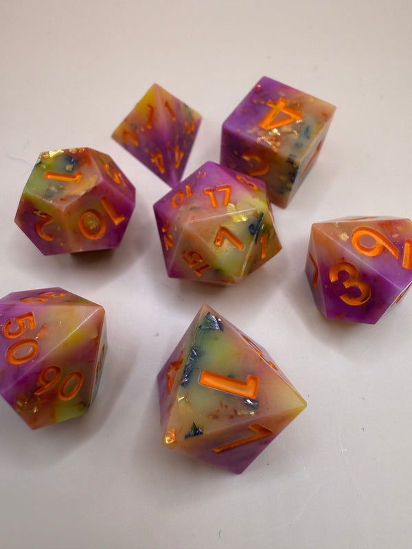 Handmade sharp-edge dragon fruit themed polyhedral dice set with vivid pink, yellow, orange colors