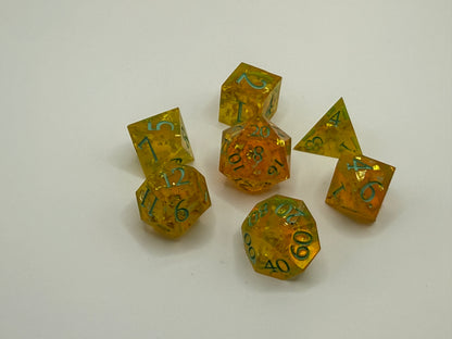 Set of amber-colored polyhedral dice with green numbers on a white background