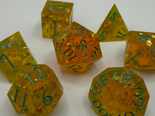 Set of transparent yellow polyhedral dice with green numbers on a white background