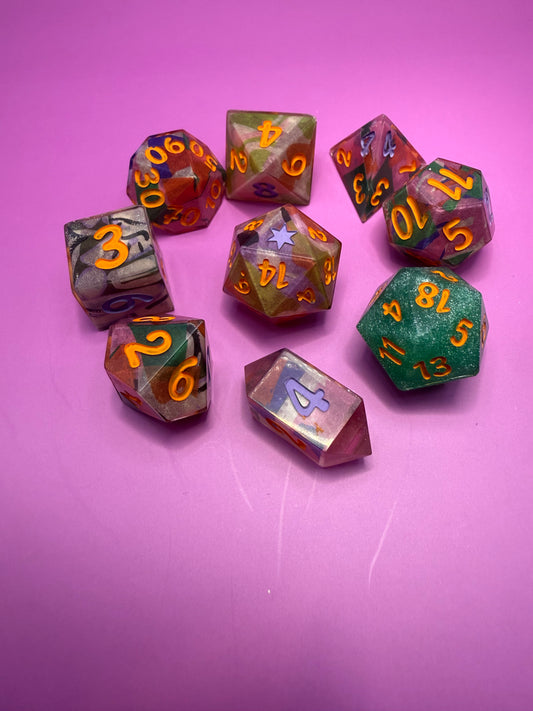 Set of colorful polyhedral dice on a pink background