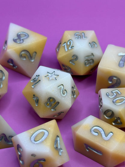 Set of polyhedral dice with numbers on a pink background