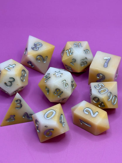 Set of polyhedral dice with numbers on a pink background