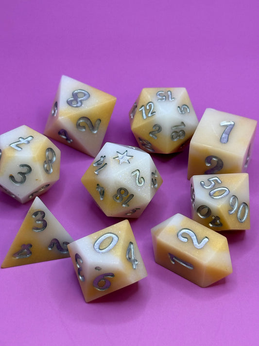 Set of polyhedral dice with numbers on a pink background