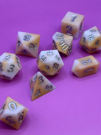 Set of polyhedral dice on a pink background