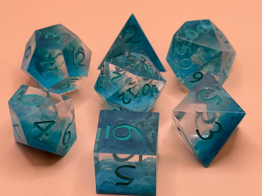 Set of blue polyhedral dice on a peach background